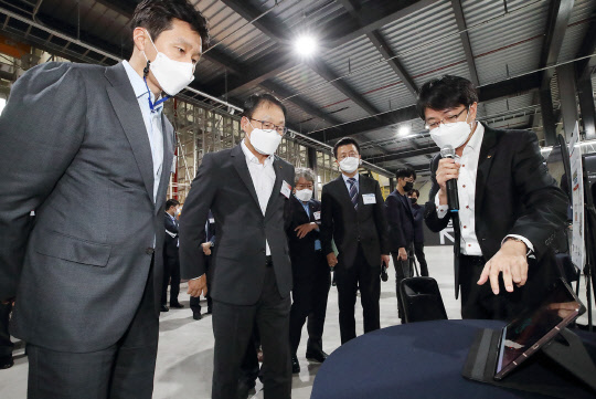 구현모(왼쪽 두번째) KT 대표와 정기선(첫번째) 현대중공업지주 부사장 등 양사 관계자들이 로봇물류시스템 데모센터에서 5G 기반 AI 무인지게차에 대한 설명을 듣고 있다.  KT 제공